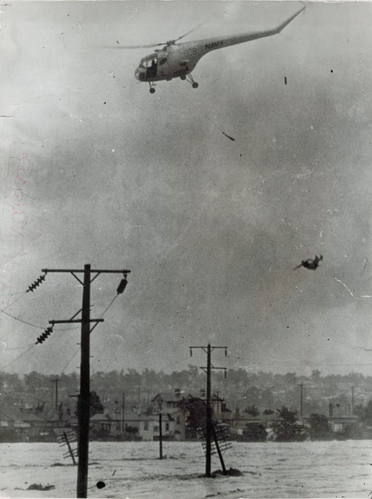 1955 image of man falling from rescue helicopter during Maitland floods.