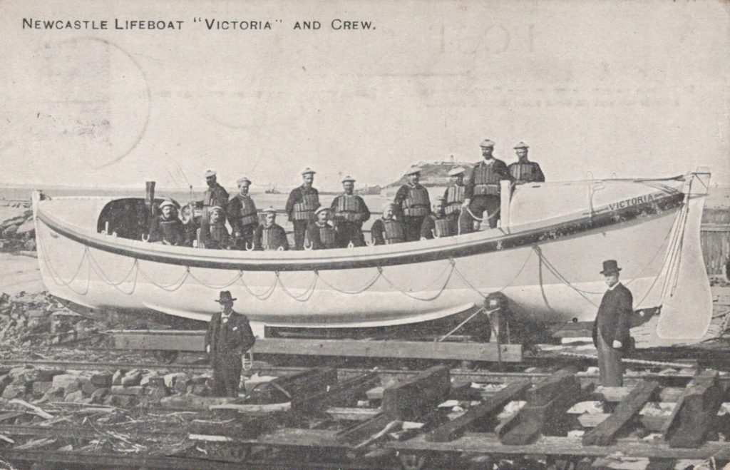 1912 postcard featuring a photo of the Victoria Lifeboat crew in Newcastle, Australia. 